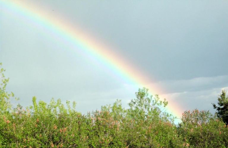 A rainbow landing at the lap of the Himalayas