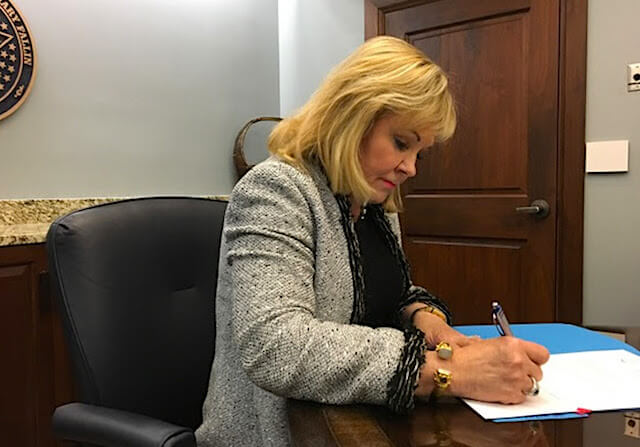 Fallin signs ‘ball and dice,’ repeal of hotel-motel tax
